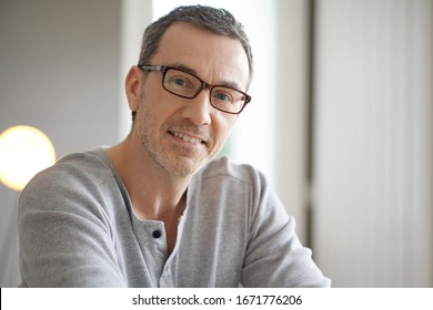 Portrait of smiling middle-aged man with eyeglasses