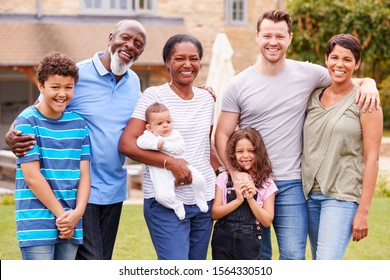 Portrait Of Smiling Multi-Generation Mixed Race Family In Garden At Home - Powered by Shutterstock