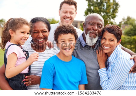 Portrait Of Smiling Multi-Generation Mixed Race Family In Garden
