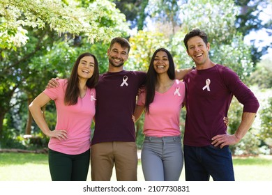 Portrait of smiling multiracial men and women wearing breast cancer awareness ribbons in park. breast cancer awareness campaign, friendship and unity concept. - Powered by Shutterstock