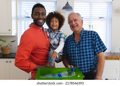 Portrait of smiling multiracial multigeneration family standing by plastic bottles in recycling bin. Unaltered, togetherness, childhood, retirement, environmental conservation, waste management, home. - Powered by Shutterstock