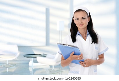 Portrait Of Smiling Nurse In Clinic Waiting Room, Healthcare, Medical.