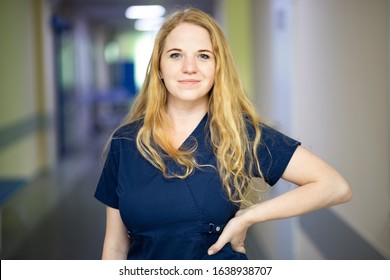 Portrait Of Smiling Nurse In Hospital Hallway