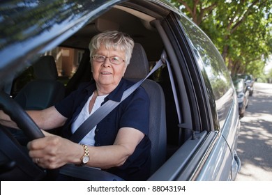 Portrait Of Smiling Old Woman Driving Car