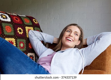 Portrait Of A Smiling Older Woman Lying Down On Couch