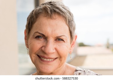 Portrait Of Smiling Older Woman With Short Hair (selective Focus)