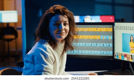 Portrait of smiling photographer enhancing images quality, correcting flaws and adjusting color, contrast, and brightness. Joyous photo editor editing photographs at office desk, camera A - Powered by Shutterstock