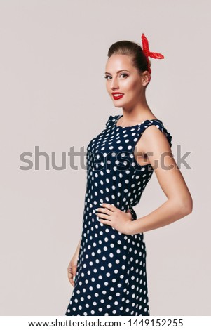 portrait of smiling pin up woman in polka dot dress. cute girl in retro style