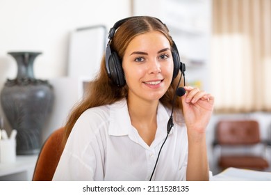 Portrait Of Smiling Polite Friendly Woman Helpline Operator With Headphones During Work In Call Center..