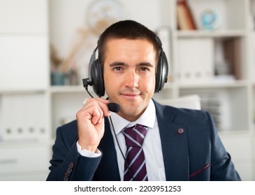 Portrait Of Smiling Polite Man Customer Support Phone Operator With Headphones During Work In Call Center