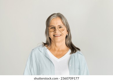 Portrait of smiling pretty gray haired caucasian elderly lady in glasses, casual look at camera, isolated on white studio background, copy space. Beauty, health care, parent lifestyle, ad and offer - Shutterstock ID 2360709177