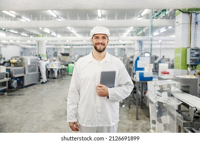 Portrait of a smiling quality control worker dispatching meat factory. - Powered by Shutterstock