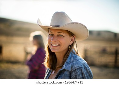 Portrait Of A Smiling Rancher Wearing A Cowboy Hat While Out On The Ranch.