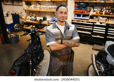 Portrait of smiling repairman working in motorcycle garage - Powered by Shutterstock