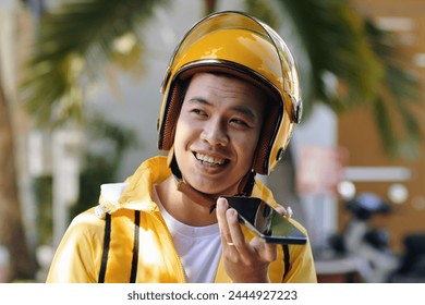 Portrait of smiling restaurant courier recording voice message for manager - Powered by Shutterstock