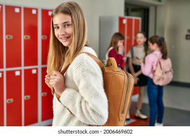 Portrait of smiling schoolgirl standing in school corridor                                - Powered by Shutterstock