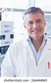 Portrait Of A Smiling Scientist Wearing Lab Coat In Laboratory