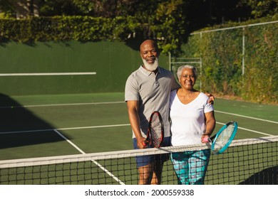 Portrait of smiling senior african american couple with tennis rackets on tennis court. retirement and active senior lifestyle concept. - Powered by Shutterstock