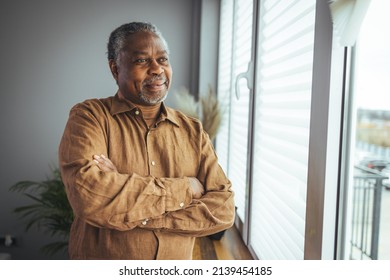 Portrait of smiling senior african american man at home near window. Portrait Of Happy Senior Man At Home. Happy mature African American man smiling - Shutterstock ID 2139454185