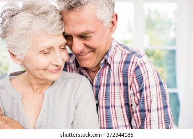 Portrait Of Smiling Senior Couple At Home