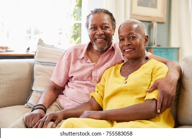 Portrait Of Smiling Senior Couple Sitting On Sofa At Home - Shutterstock ID 755583058