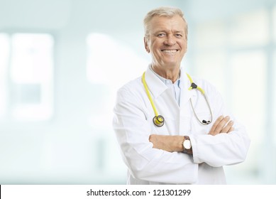 Portrait of a smiling senior doctor standing in the hospital - Powered by Shutterstock