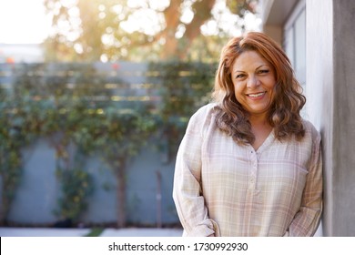 Portrait Of Smiling Senior Hispanic Woman In Garden At Home Against Flaring Sun - Shutterstock ID 1730992930