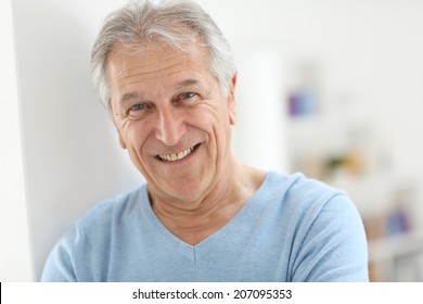 Portrait Of Smiling Senior Man With Blue Shirt