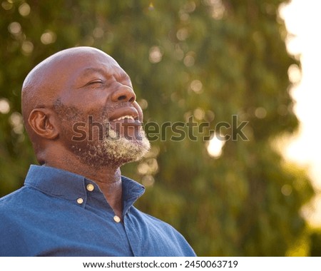 Portrait Of Smiling Senior Man Outdoors In Countryside Relaxing Closing Eyes And Taking Deep Breaths