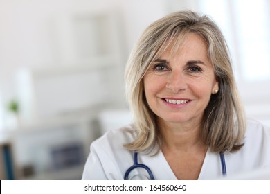 Portrait Of Smiling Senior Nurse In Hospital