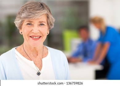 portrait of smiling senior woman in doctor's office
