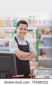 Portrait of a smiling shopkeeper in a grocery store - Shutterstock ID 753589222