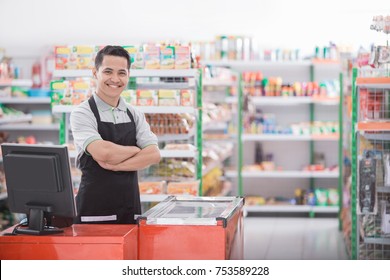 Portrait of a smiling shopkeeper in a grocery store - Shutterstock ID 753589228
