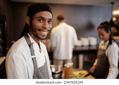 Portrait of smiling sous-chef enjoying working in kitchen of popular hotel - Powered by Shutterstock