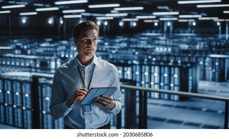 Portrait of Smiling IT Specialist Using Tablet Computer in Data Center. Big Server Farm Cloud Computing Facility with Male Maintenance Administrator Working. Cyber Security, e-Business. - Powered by Shutterstock