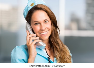 Portrait Of A Smiling Stewardess Talking On The Phone