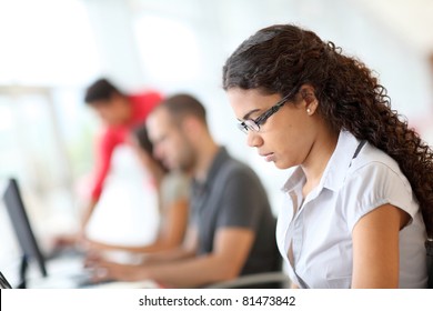 Portrait Of Smiling Student In Front Of Laptop Computer