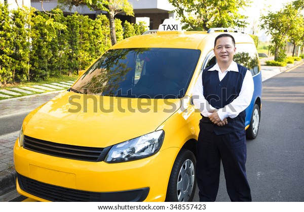 portrait of smiling taxi\
driver with car