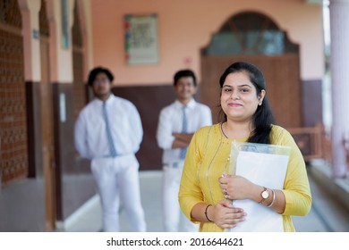 portrait of Smiling teacher in School corridor	
