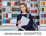 Portrait of smiling teenage girl student, inside high school building