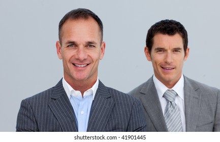 Portrait Of Smiling Two Businessmen With Folded Arms