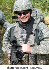 The Portrait Of The Smiling US Army Soldier With Machine Gun