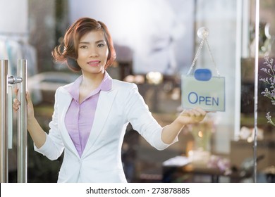 POrtrait of smiling Vietnamese business woman opening store - Powered by Shutterstock