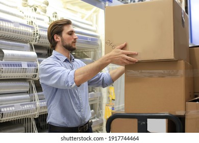 Portrait of a smiling warehouse keeper at work - Shutterstock ID 1917744464