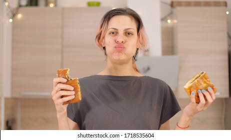 Portrait Of Smiling Woman With Dirty Ketchup Face, Greedily Eagerly Eating Food During Quarantine Due To Coronavirus. Charming Happy Hungry Woman Holds In Hands Big Meat Pie. 