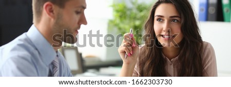 Portrait of smiling woman discussing with colleague new business project. Interesting exchange of ideas between coworkers. Office life and biz career concept