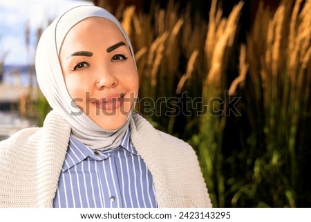 portrait of smiling woman in hijab. Beautiful nature of the Norwegian park. High quality photo
