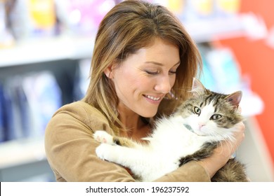 Portrait Of Smiling Woman Holding Cat 