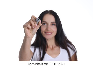 Portrait Of Smiling Woman Holding Marker And Writing Something In Air. Young Cheerful Female Drawing Something On Virtual Screen. People Lifestyle Concept