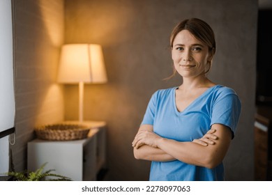 Portrait of smiling woman looking at camera. Successful middle aged woman at home smiling. Beautiful mid adult lady in casual with long brown hair enjoying. Portrait of beautiful girl smiling  - Powered by Shutterstock